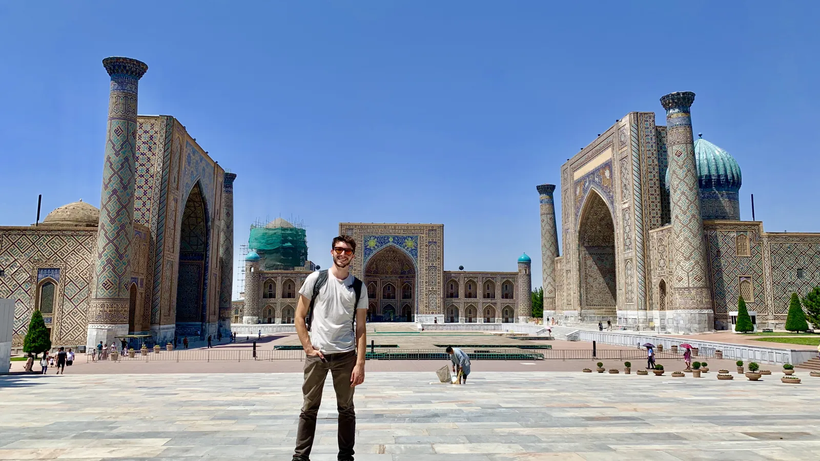 Kyle Erickson standing in front of the Registan, a collection of madrasahs built between the 15th and 17th centuries in Samarkand.