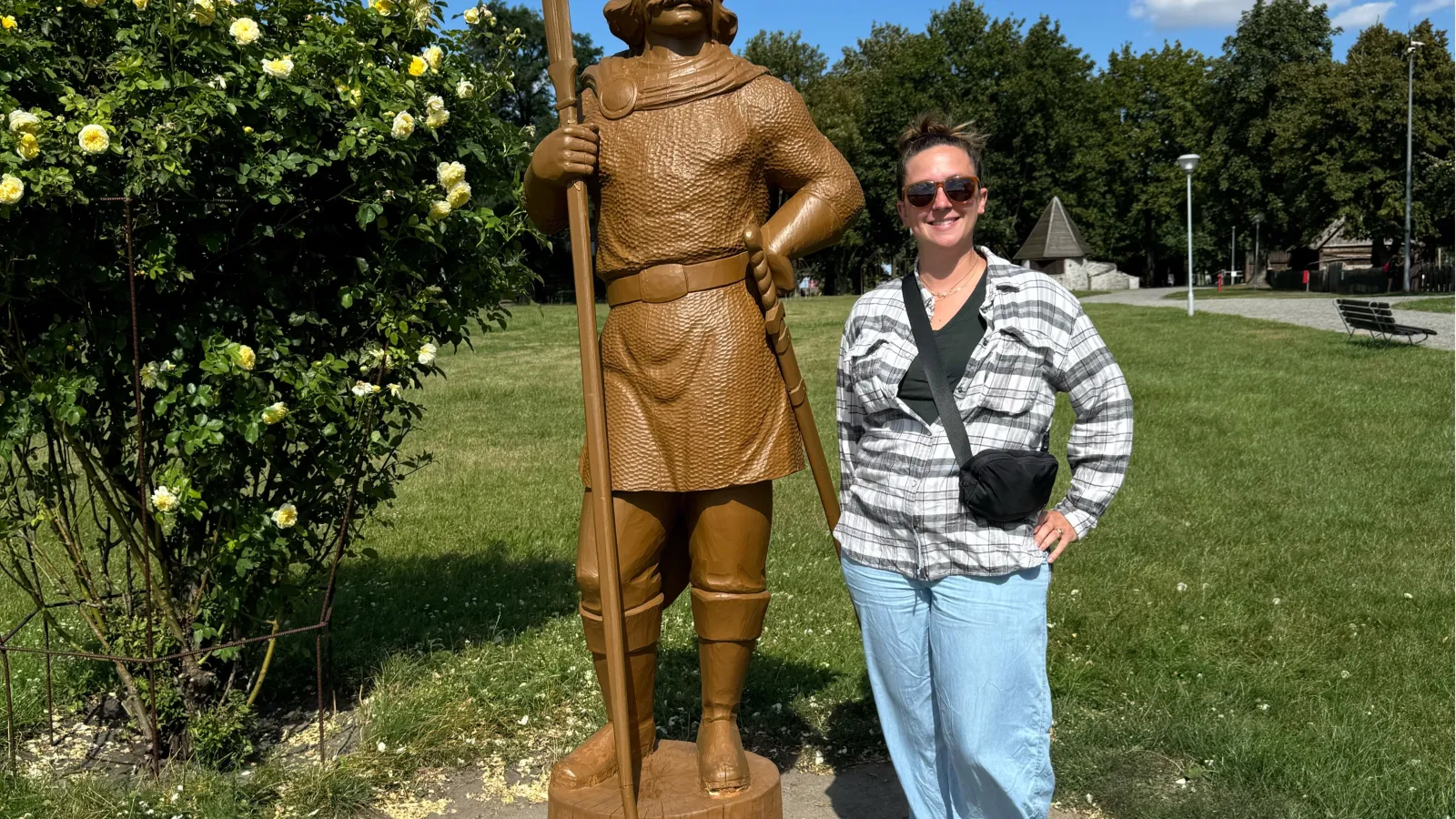 Lauren Hayden standing next to a wooden statue in Giecz, Poland