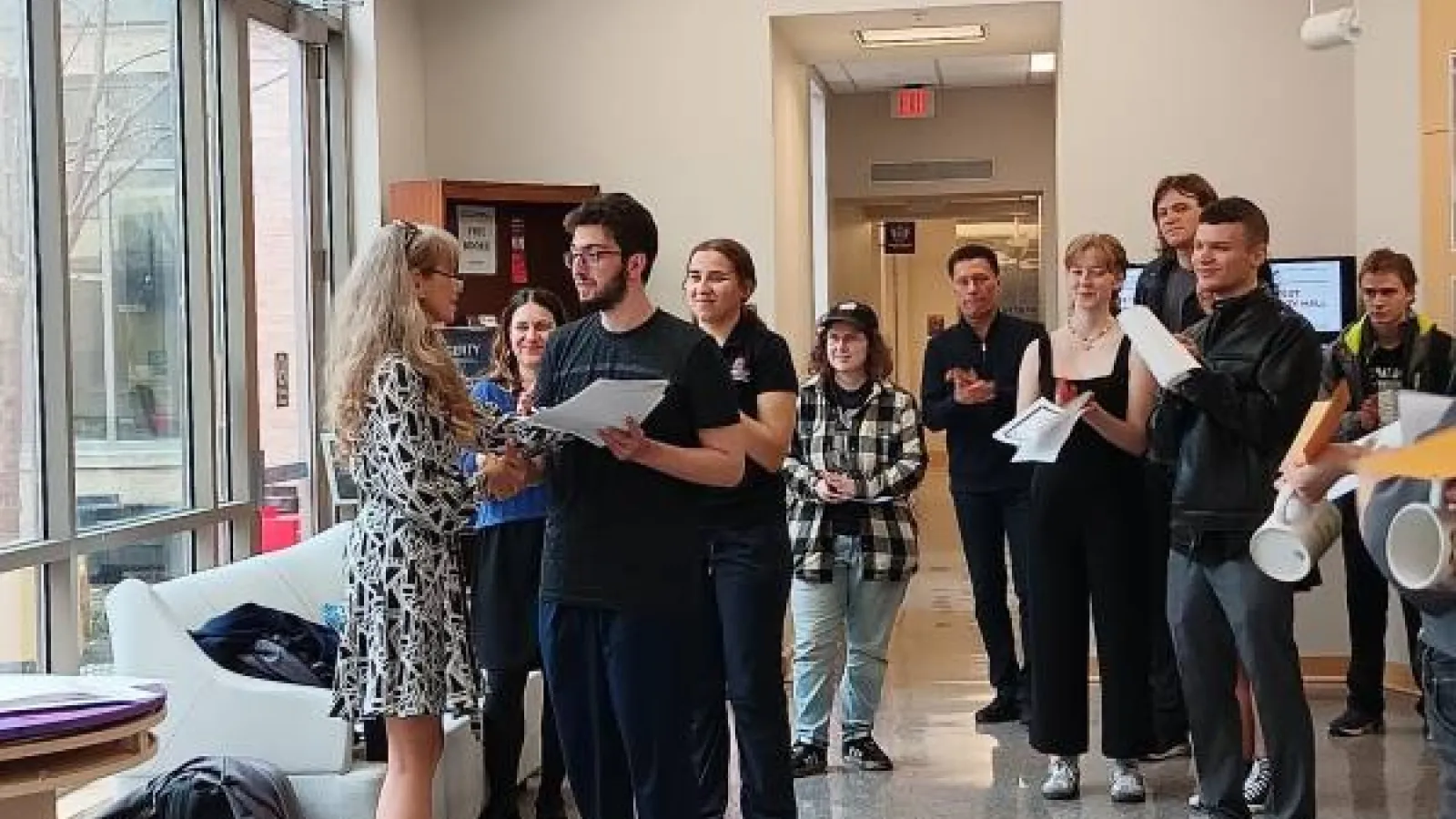 Dr. Larysa Stepanova presents FLAS Fellow William Slabodkin with a certificate as other students applaud
